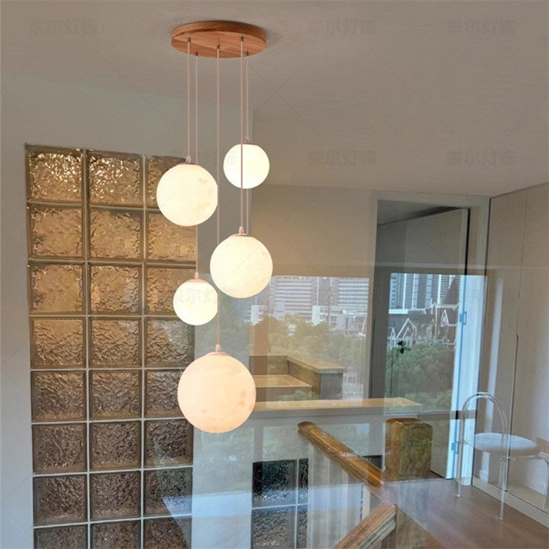 Wood globe chandelier seen from below against a white ceiling
