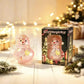 Translucent pink Santa jelly squishy squeeze toy beside its gift box