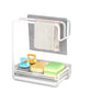 White two level kitchen cloth and sponge rack with a gray cloth, a towel, sponges and brushes on a white background