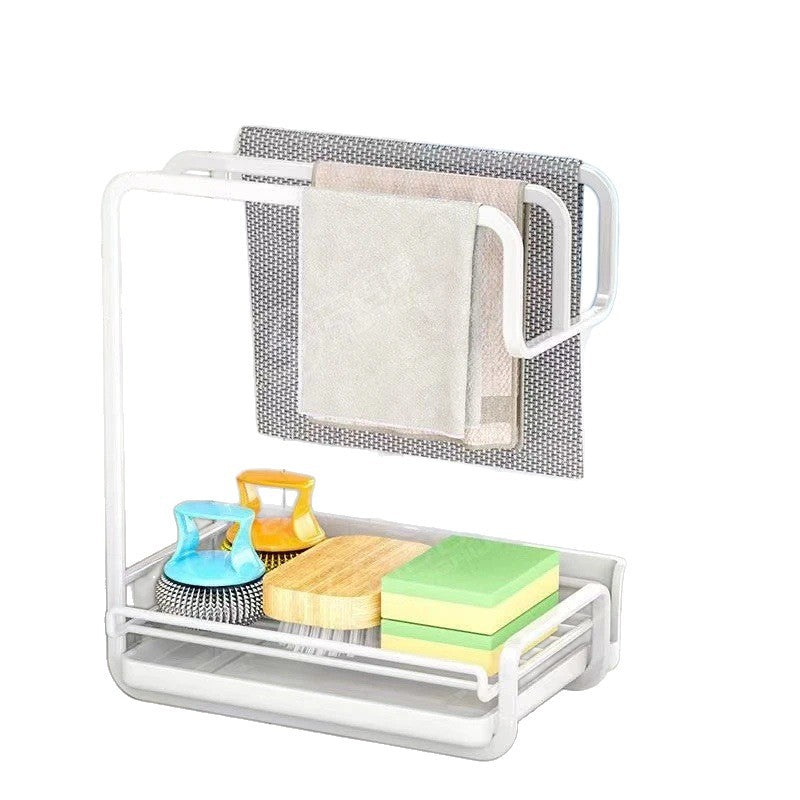 White two level kitchen cloth and sponge rack with a gray cloth, a towel, sponges and brushes on a white background