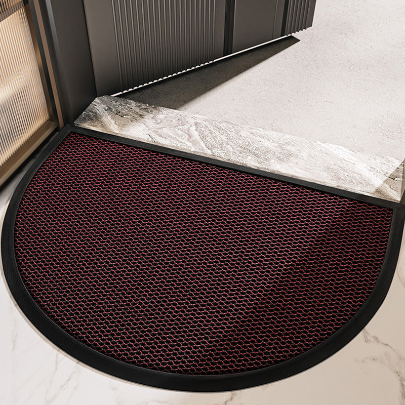 Semi circular entrance door mat with textured surface at a modern doorway