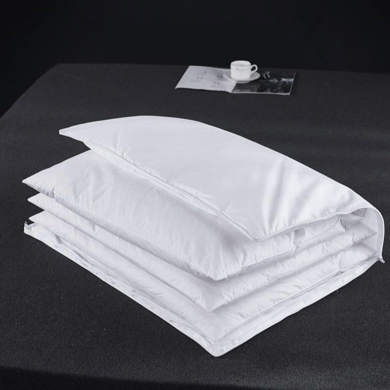 Soft white down bed pillow shown full and lofted against a plain background