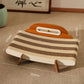 Corrugated cat lounger with size labels 555 mm wide, 375 mm deep and 215 mm high on a carpeted floor