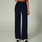 Curved back seam high waist wide leg pants on a standing model