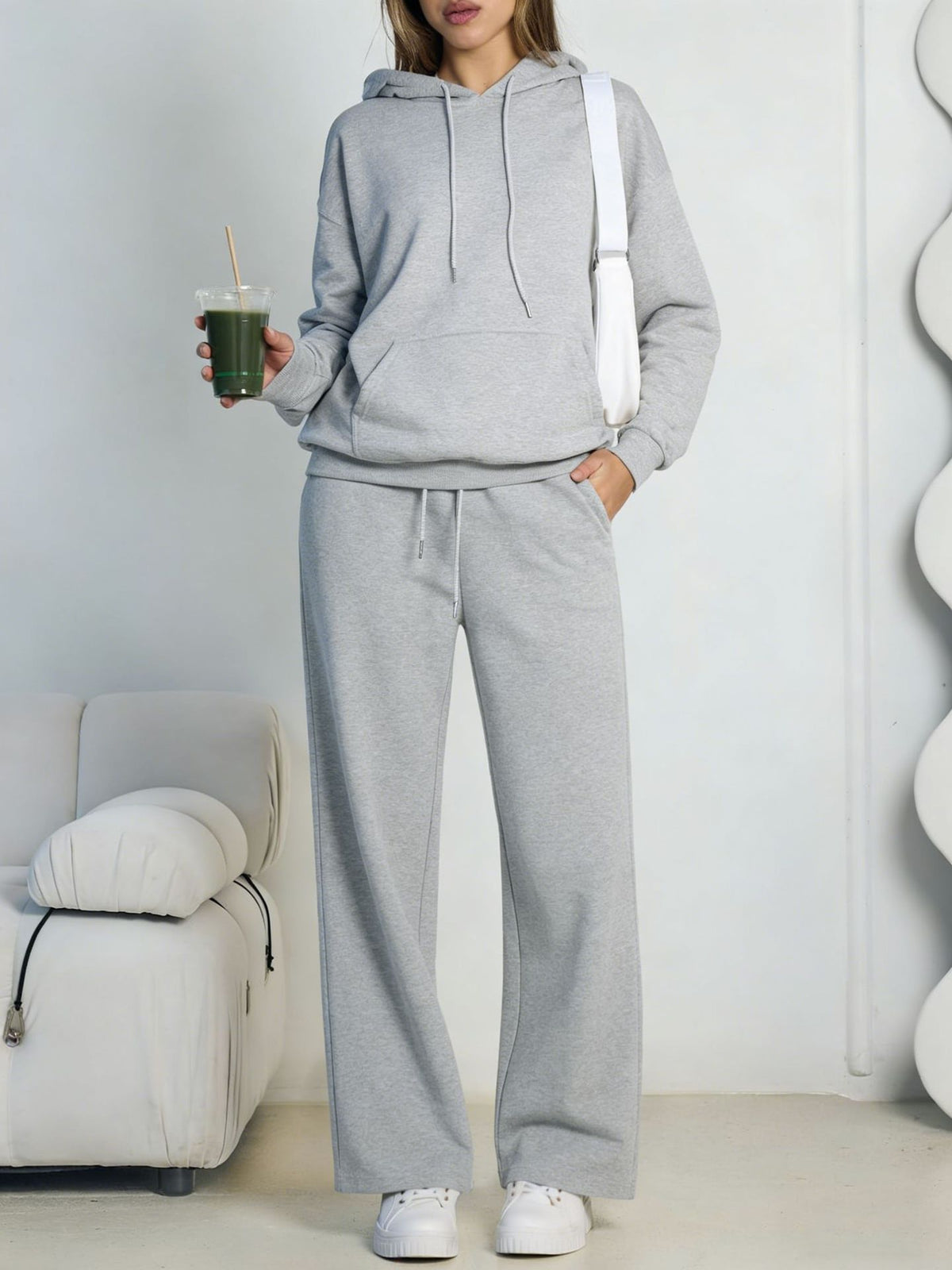 Light gray fleece hooded sweatshirt and wide-leg sweatpants set worn by a model