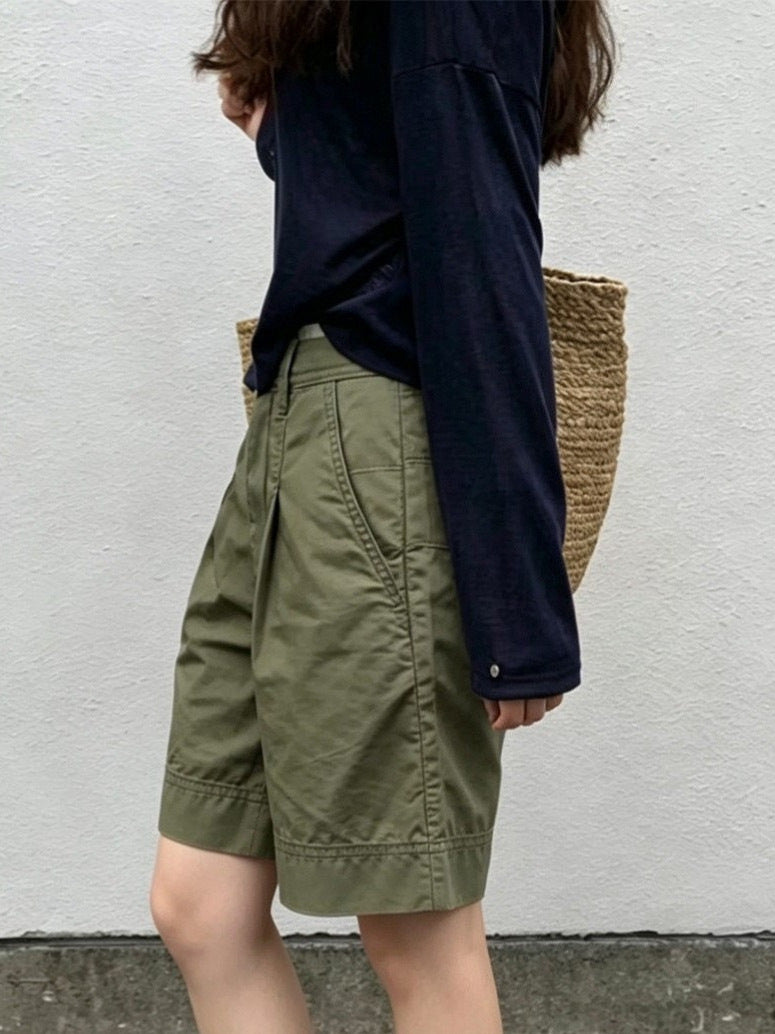 Side profile of army green pleated Bermuda shorts showing belt loops and slanted side pocket