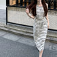 Front view of striped sleeveless maxi dress with shirred high waist and chest motif