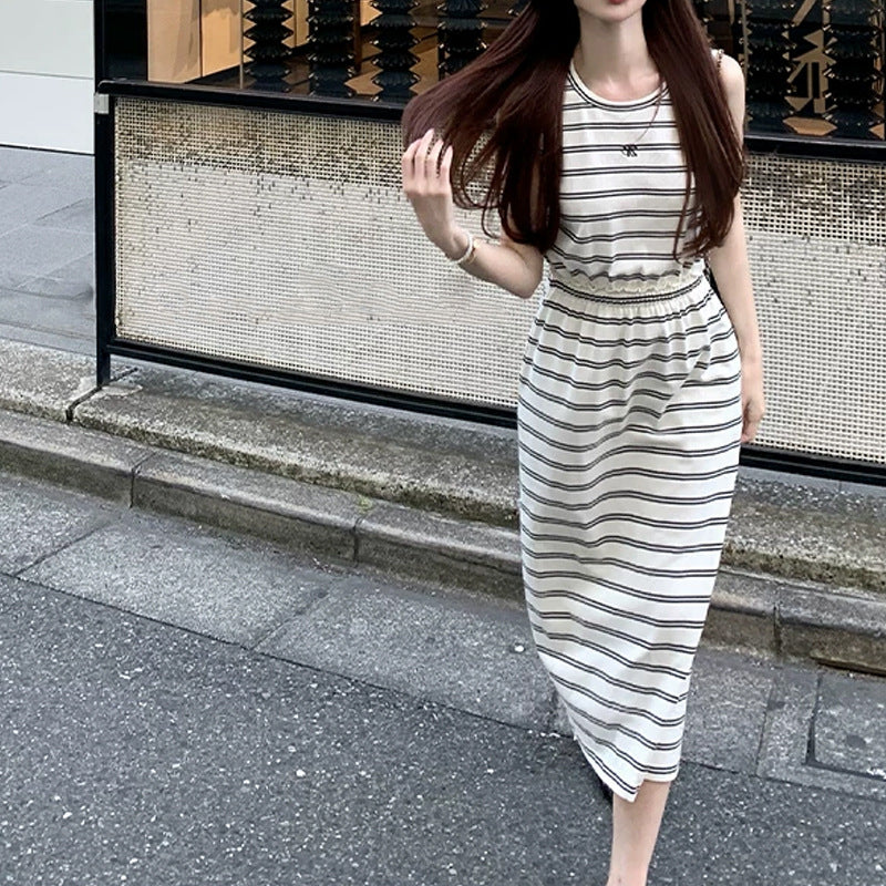 Front view of striped sleeveless maxi dress with shirred high waist and chest motif