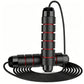 Black and red speed skipping rope standing upright with the cable coiled below