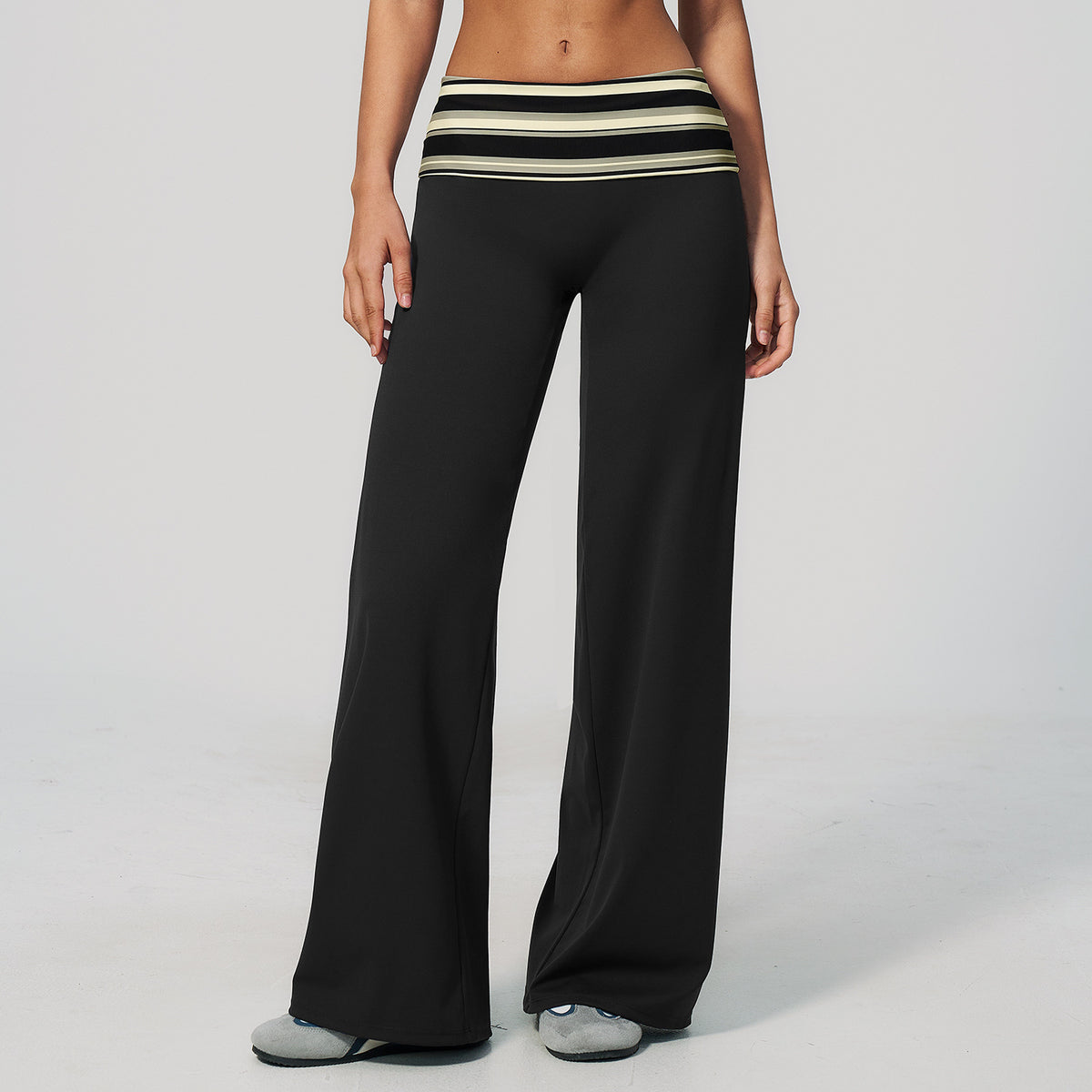 Model in wide leg pants with a fold over printed waistband, black with cream stripes