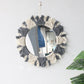 Side angle of the boho wall mirror showing the woven frame depth