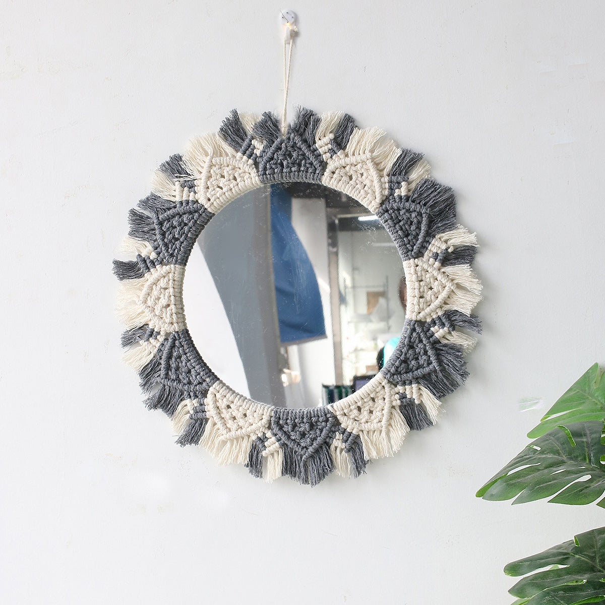 Side angle of the boho wall mirror showing the woven frame depth