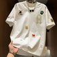 Men's loose fit embroidered patch T-shirt in white with a varsity A letter and sewn on patches
