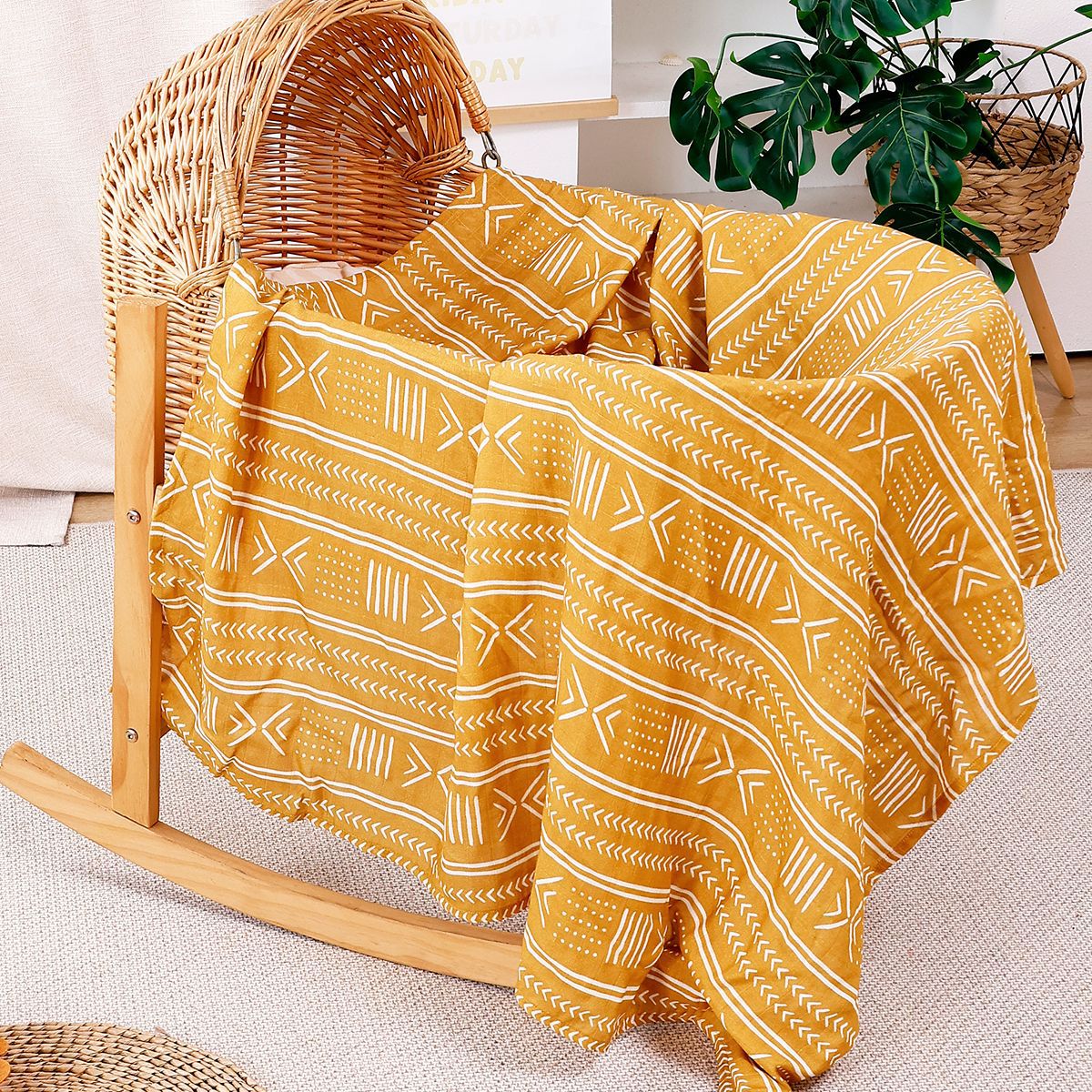 Soft cotton muslin gauze baby blanket shown folded, revealing the light open double layer weave