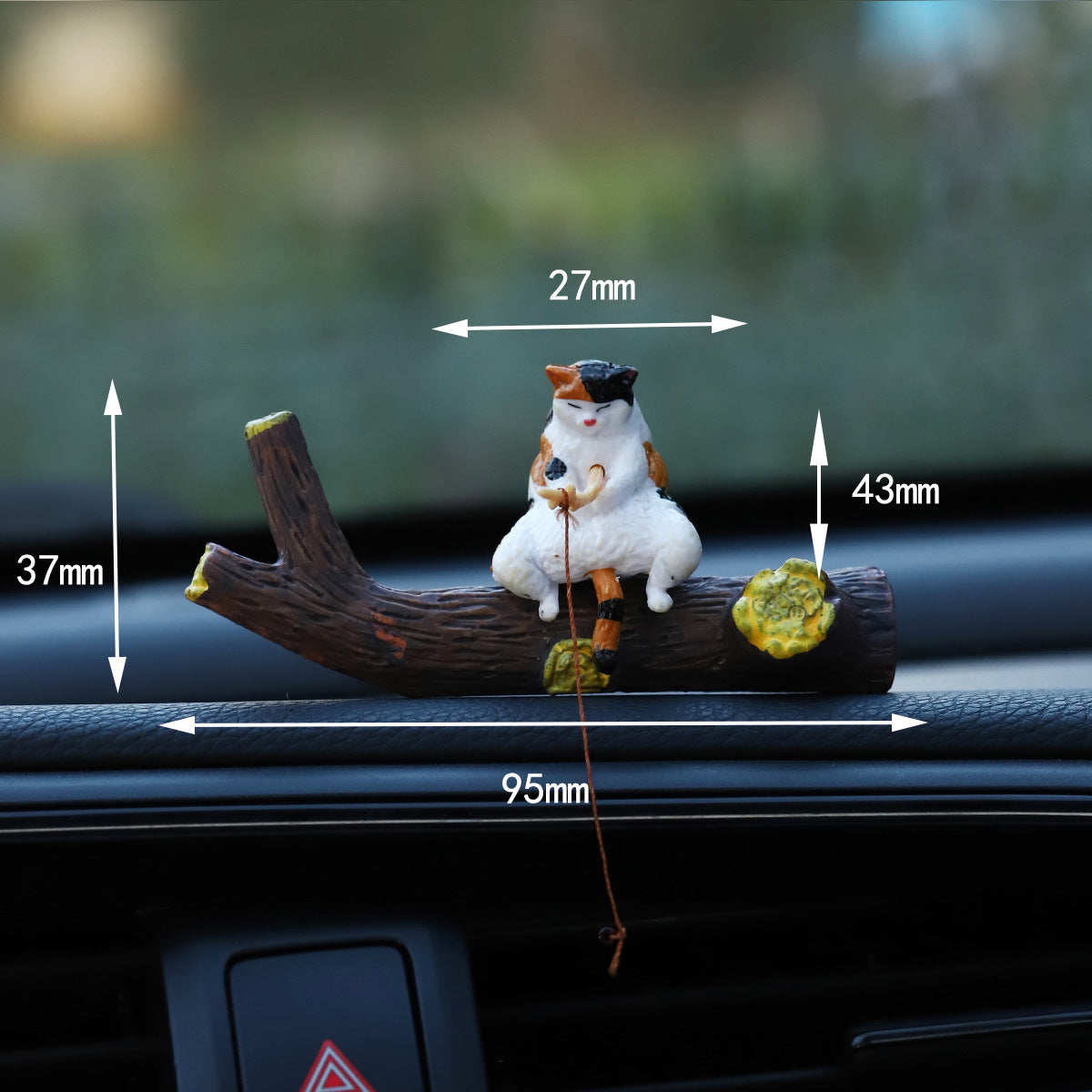 Calico cat sitting on the resin branch, maker sizes marked 27 and 43 mm