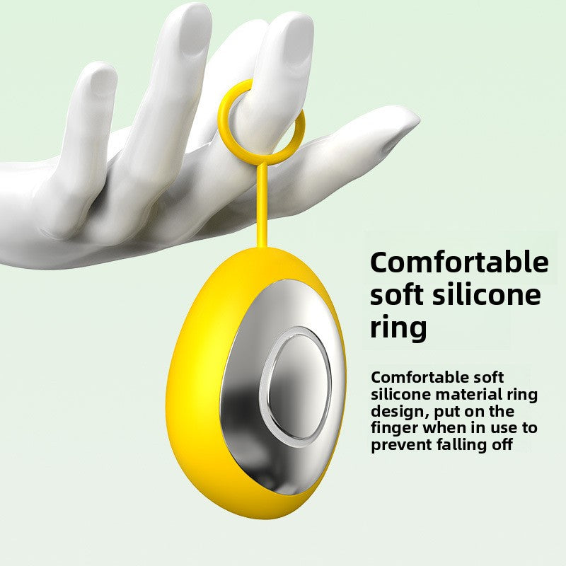 Yellow handheld sleep aid device hanging from a finger by its soft silicone ring