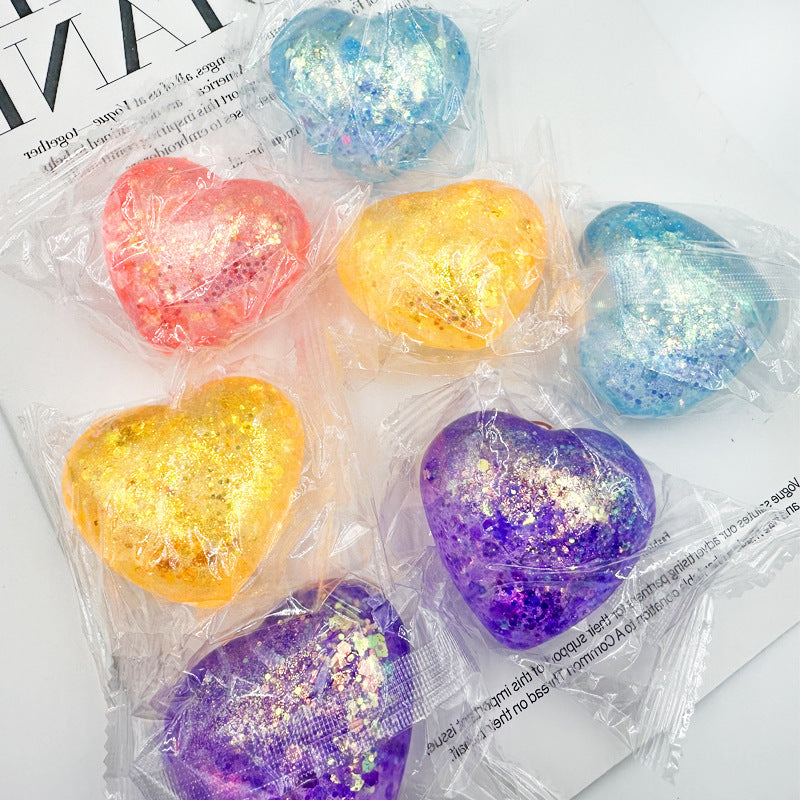 Aurora glitter hearts individually twisted into clear film, mixed pastel colours on a page