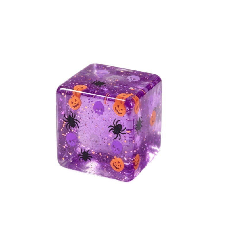Purple tinted glitter Halloween squishy cube with pumpkin skull and spider print