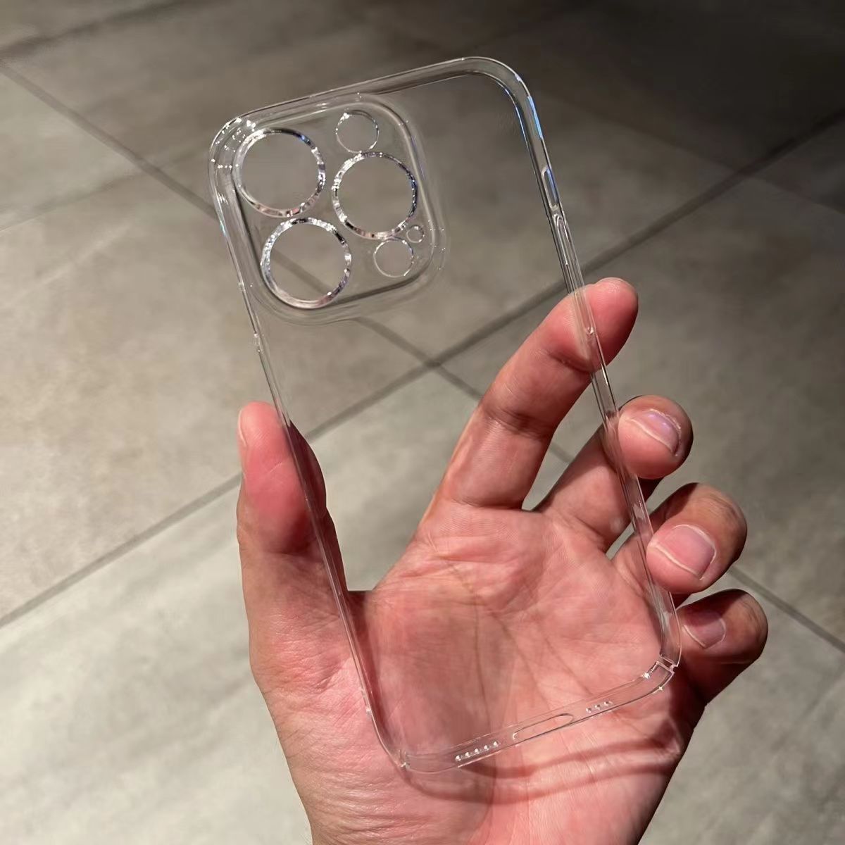 Clear hard phone case with a raised camera ring held in a hand, iPhone 13 Pro option