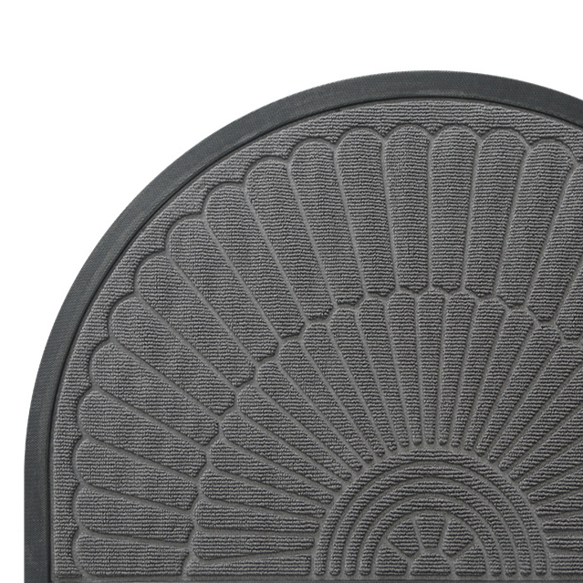 Close view of the raised fan and shell relief on a semi circular polyester door mat