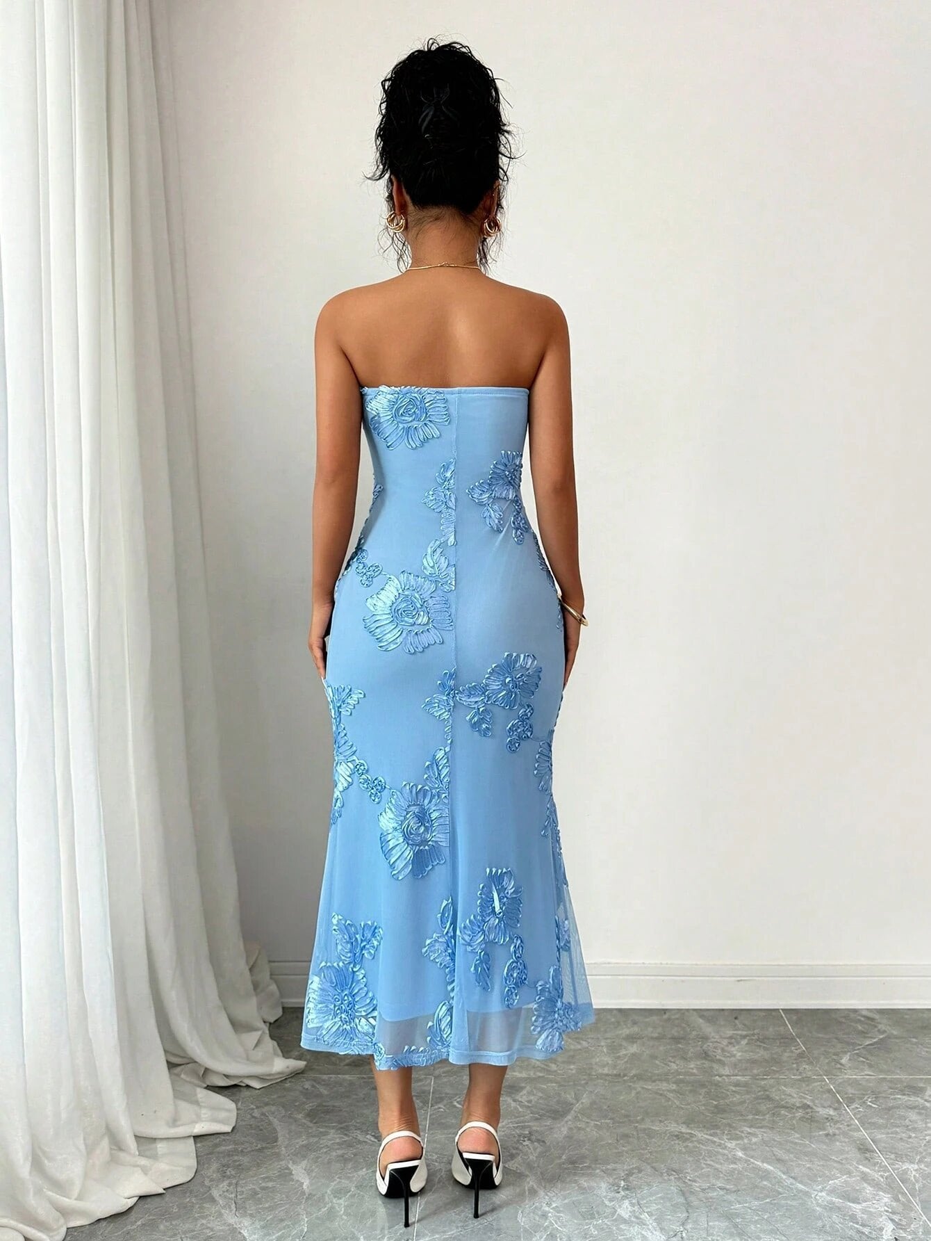 Back view of the strapless dress, mesh covering the back from the band down with a centre seam