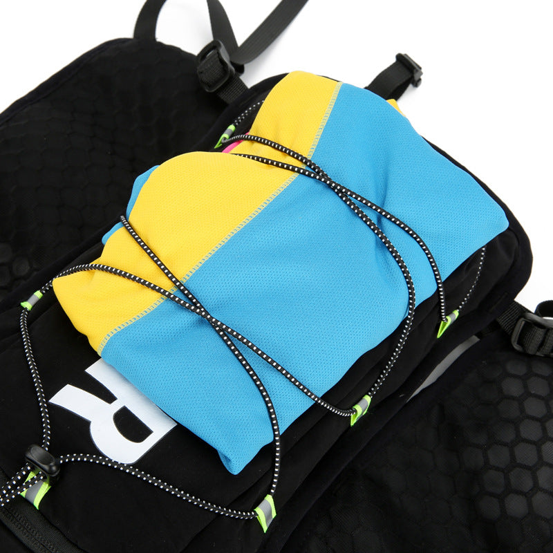 Black hydration backpack back view with honeycomb mesh panel and reflective OUTDOOR lettering