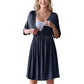 Pregnant model with a hand on the bump in a soft solid maternity dress