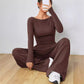 Dark brown boat neck long sleeve top and wide leg trousers two piece set, seated pose