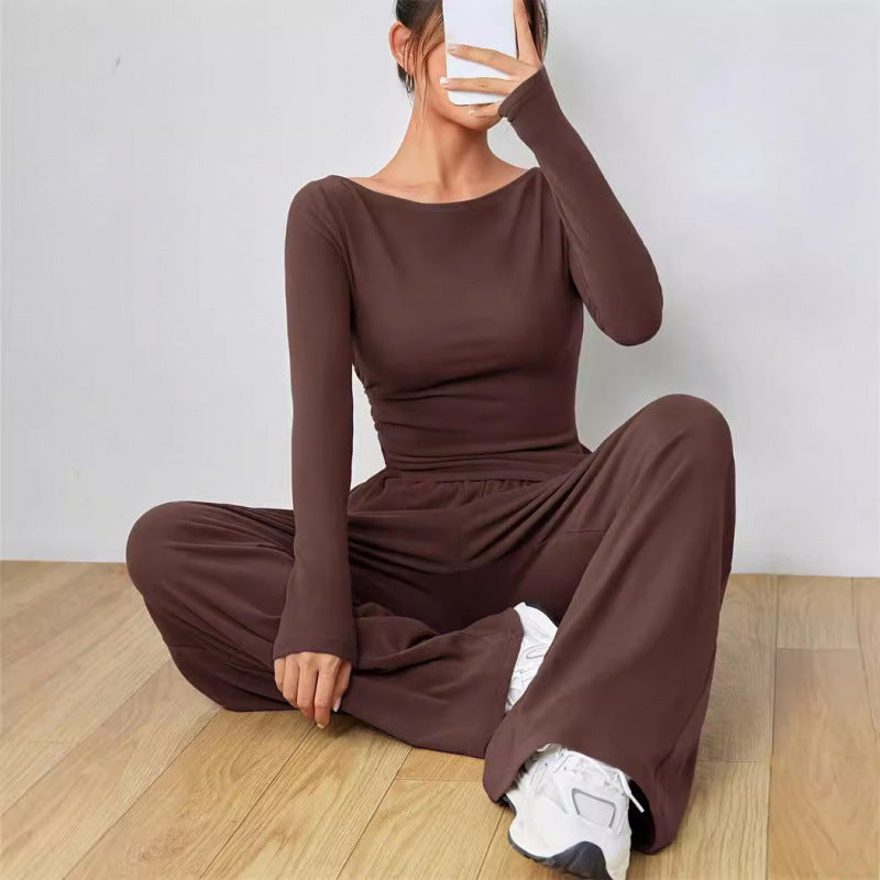 Dark brown boat neck long sleeve top and wide leg trousers two piece set, seated pose