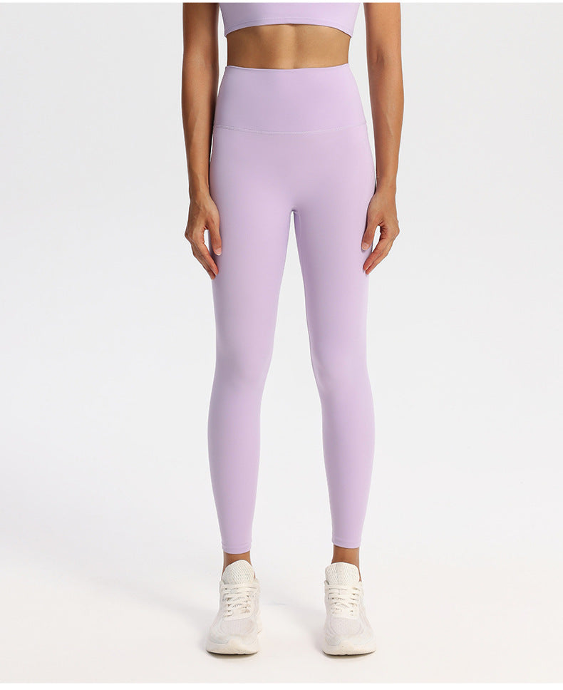 Solid-tone high-waisted yoga leggings for women in a nylon spandex knit, on a model
