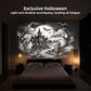 Black and white haunted house scene with bats and ghosts projected on the wall above a bed in a dark bedroom