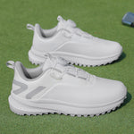 White low top golf shoe with a twist dial closure and a nubbed spikeless rubber outsole