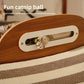 Close up of a cat paw reaching into the headboard slot to bat the catnip ball above the striped corrugated pad