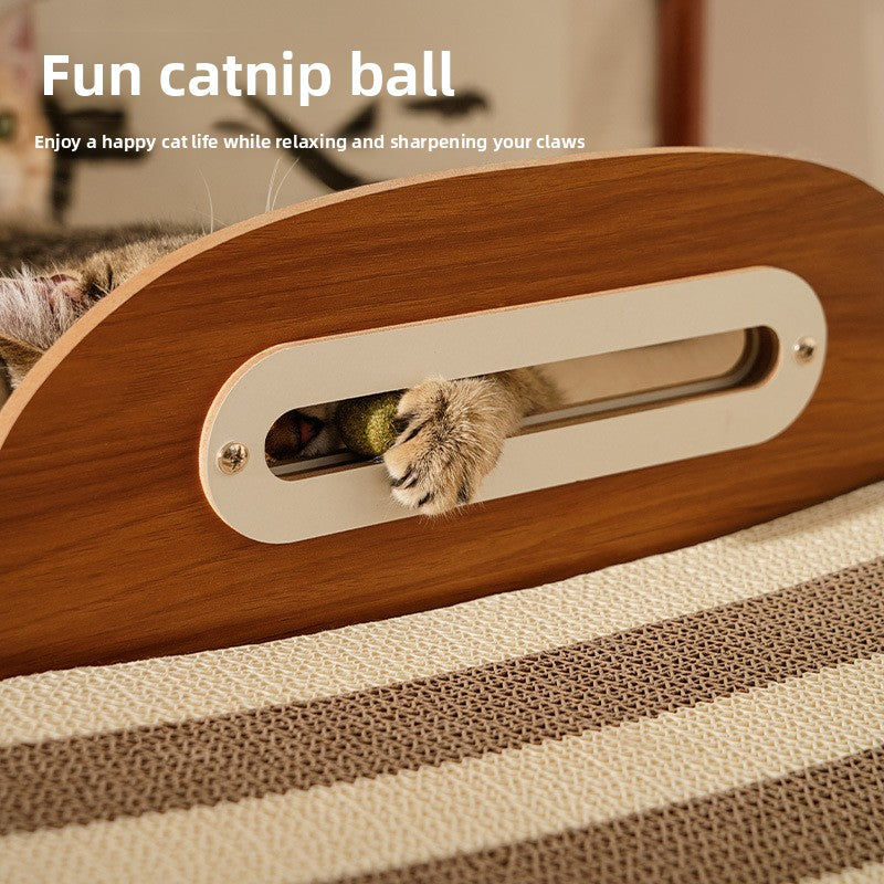 Close up of a cat paw reaching into the headboard slot to bat the catnip ball above the striped corrugated pad