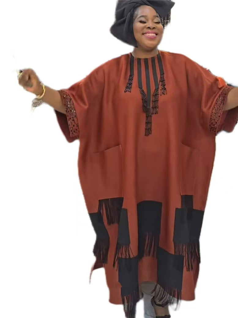 Orange red boubou kaftan dress with beaded tassel placket and fringed hem on a plain white background