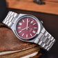 Layered styling shot with the automatic watch and a cuff