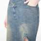 Folded skirt on a wooden hanger with the original cotton care tag visible