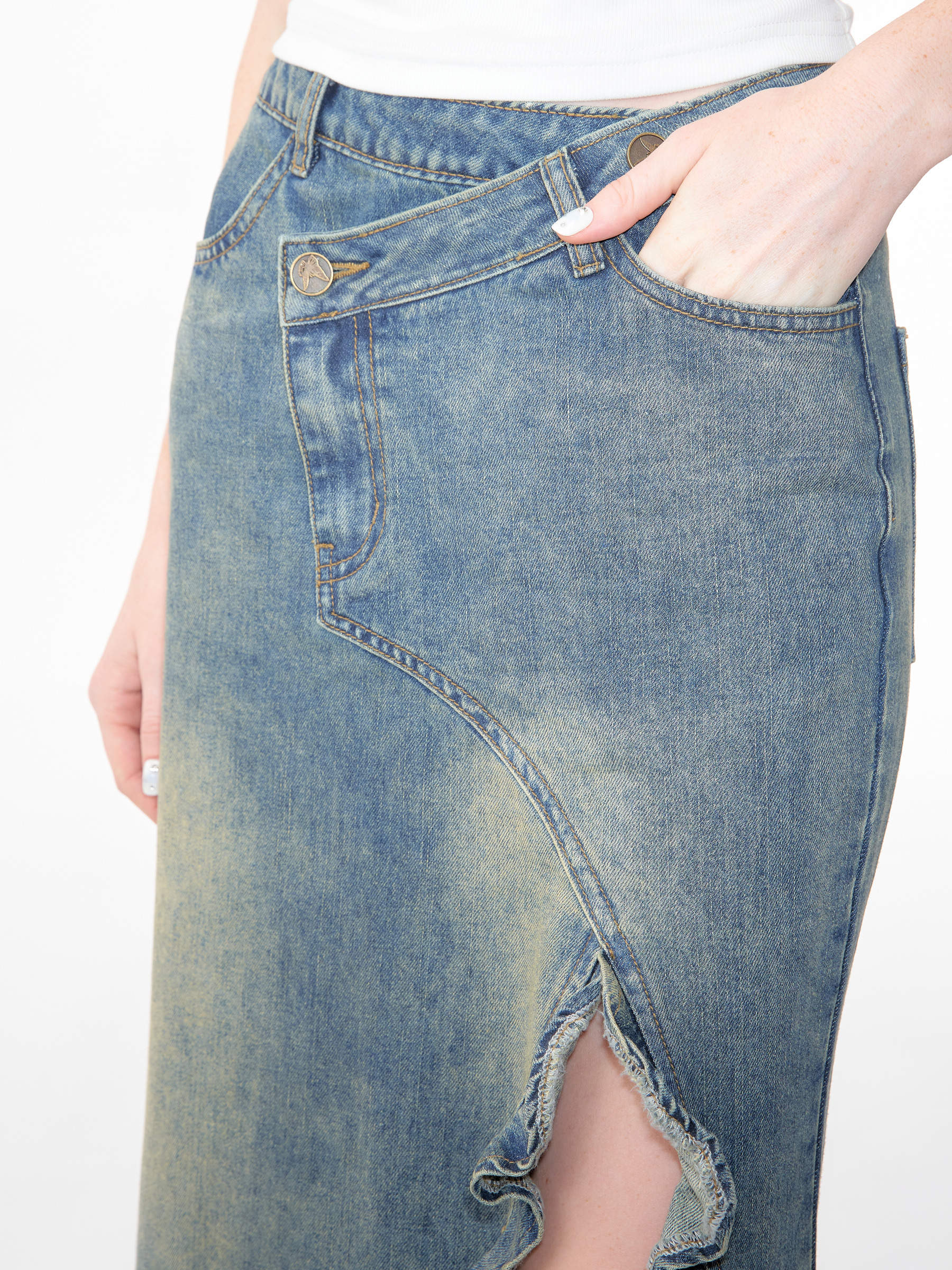 Folded skirt on a wooden hanger with the original cotton care tag visible