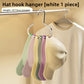 Circular hat hanger holding a row of caps in a closet lifestyle scene