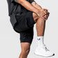 Man wearing the two in one training shorts in black, stretching, showing the fitted inner liner