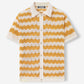 Flat lay of yellow and cream chevron ripple knit polo shirt with full button front