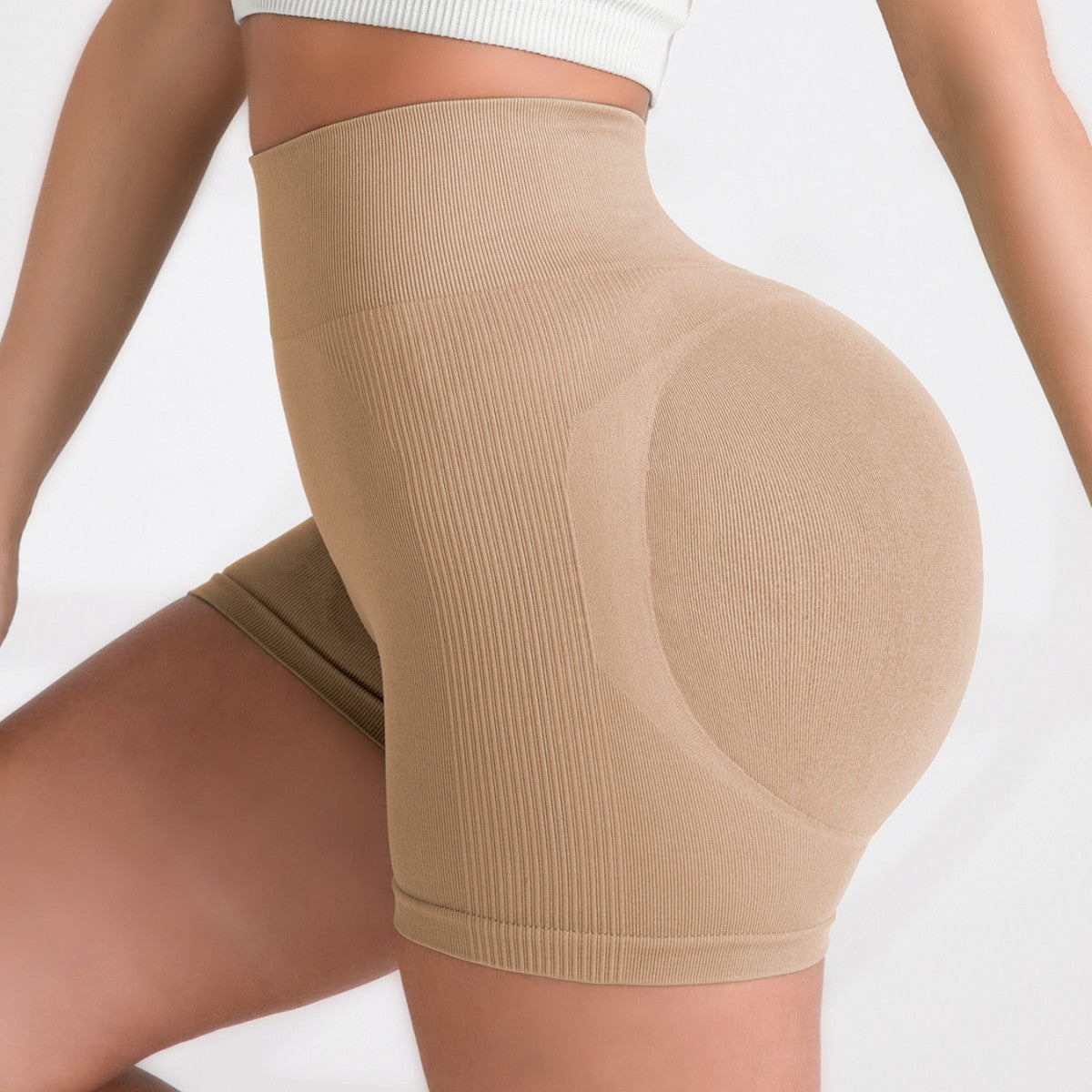 Sand ribbed shorts on a plain studio background, fine vertical rib visible all over