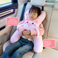 Animal shaped plush car headrest nap pillow shown on a car seat