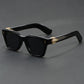 Sand white framed square sunglasses with an emerald tinted lens on a grey surface