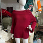 Deep red off-shoulder knit sweater with wide sleeves shown on a mannequin