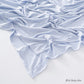 Corner of the modal cotton headscarf wrap showing the neat rolled hem and flat solid color