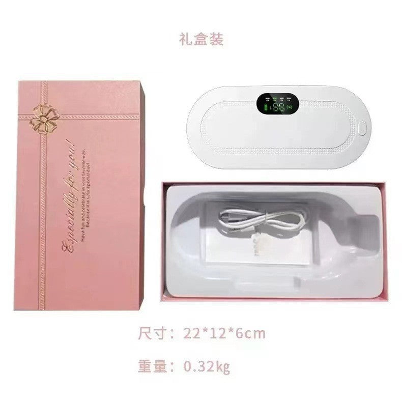 Pink gift box opened to show the white heating belt and a coiled white USB charging cable