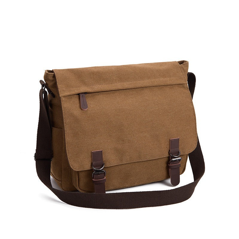 Brown canvas messenger bag with front flap, two leather strap clasps and a wide webbing shoulder strap