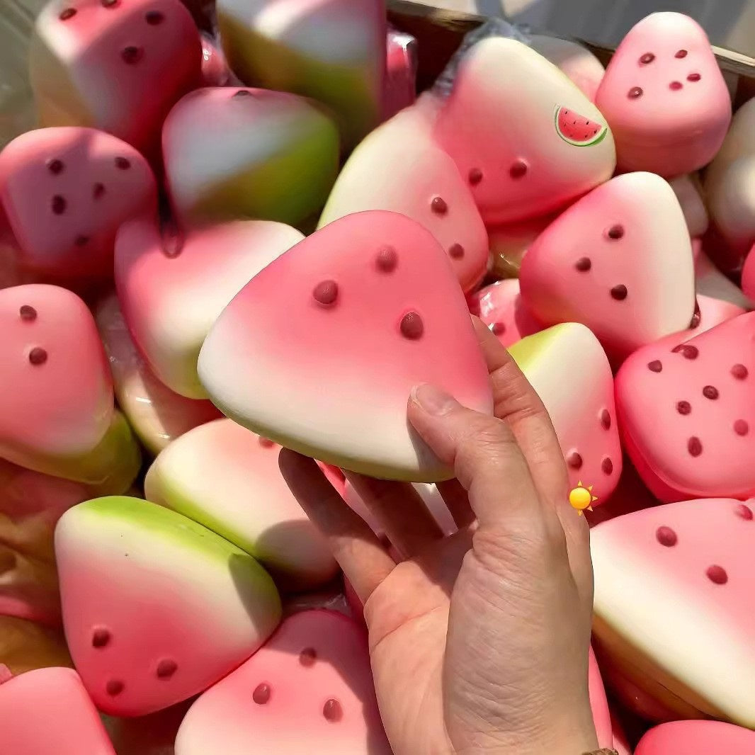 Set of fruit squishy toys including watermelon and strawberry on a bright summer background