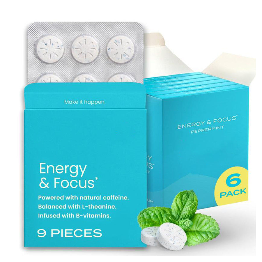 Teal box of peppermint caffeine chewing gum with a blister of nine scored tablets and fresh mint leaves